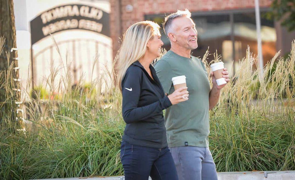 couple walking and drinking coffee
